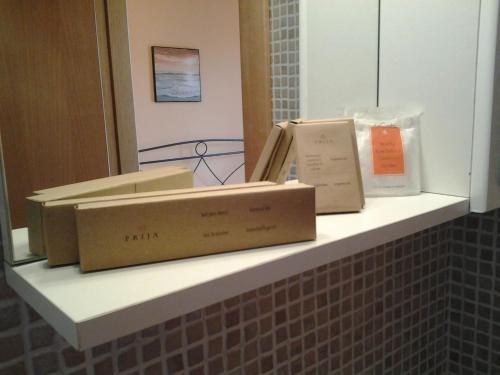 three boxes sitting on a shelf in a bathroom at B&B Terra Serena in Santa Cesarea Terme