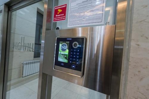 a stainless steel refrigerator with a digital screen on it at THEADDRESS HIGHVILL Lux in Astana