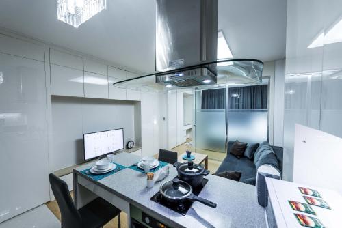 a kitchen and living room with a table and a couch at THEADDRESS HIGHVILL Lux in Astana