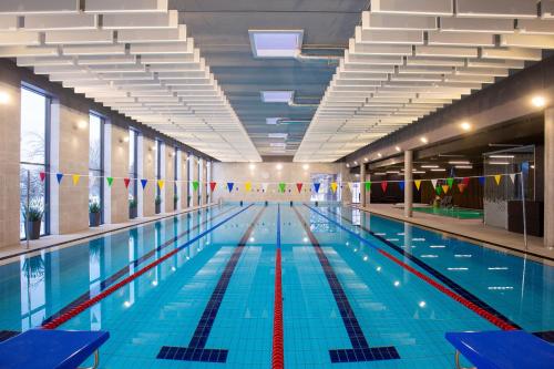 una piscina vacía con banderas en un edificio en Paide SPA Hotell, en Paide