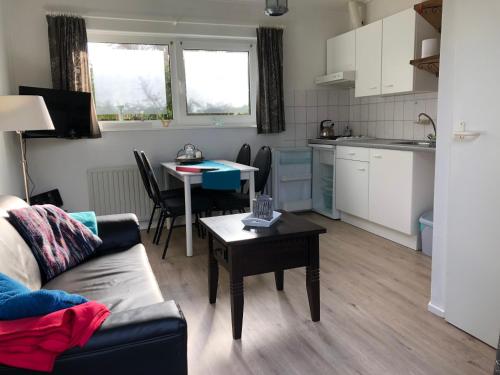 a living room with a couch and a table at Hello Zeeland - vakantiewoning Porrenaerstraat 2 in Aagtekerke