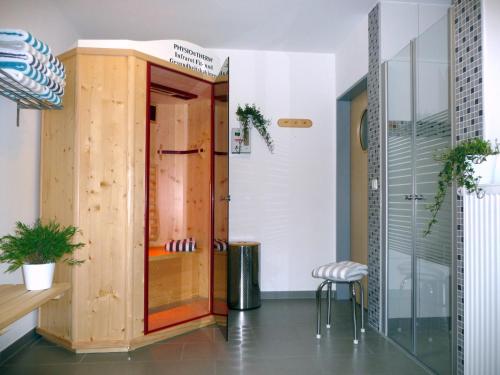 Pokój z prysznicem i drewnianymi drzwiami w obiekcie Meeresblick Fehmarn Ferienhaus 42 w mieście Fehmarn