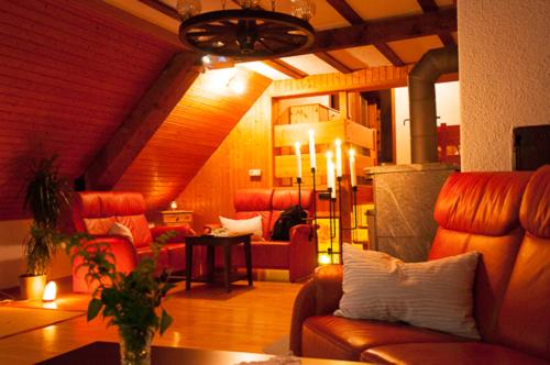 a living room with a couch and a table at Ferienhaus Hinterzarten in Hinterzarten