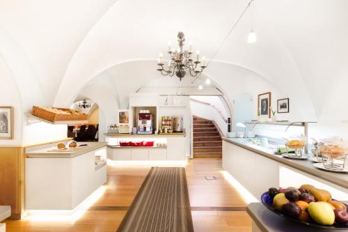 a kitchen with a table with a bowl of fruit at Hotel Restaurant Höldrichsmühle in Hinterbrühl