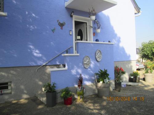 a blue building with clocks on the side of it at Gîte du Coq in Lingolsheim