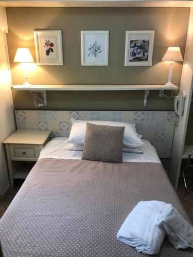 a bedroom with a bed with a white blanket at Hotel Europeo Napoli in Naples