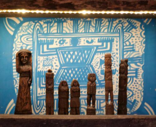 a group of wooden figurines in front of a cake at Azienda Agricola Il Querceto in Marsico Vetere