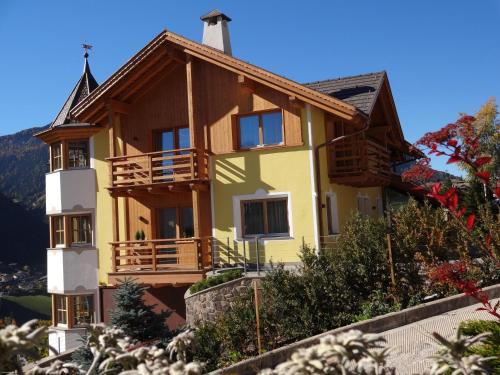 a house on top of a hill at Chalet Residence Alpinflair in Ortisei