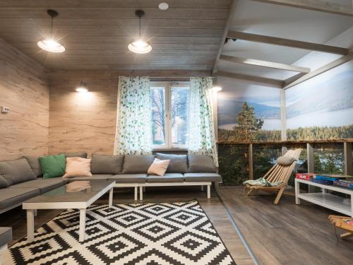 a living room with a couch and a large window at Eurohostel in Helsinki
