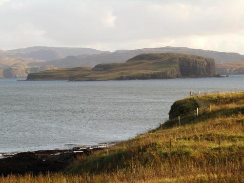 a large body of water with hills in the background at Harlosh Hideaways - Aurora Pod in Harlosh
