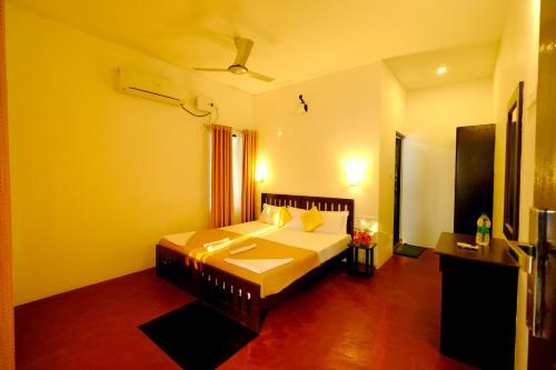 a bedroom with a bed in a room at Marari Lotus Beach Villa in Mararikulam