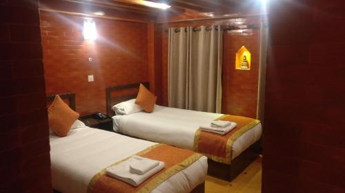 a hotel room with two beds and a mirror at Temple House in Kathmandu