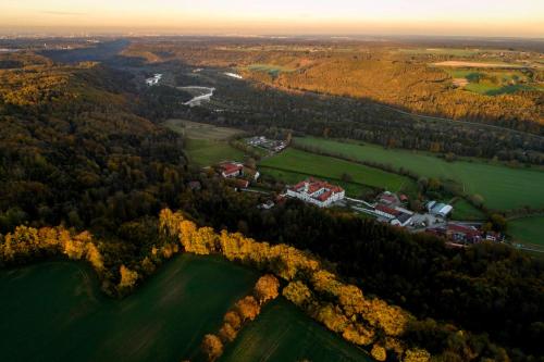an aerial view of a farm in the forest at Hotel Gut Schwaige in Ebenhausen