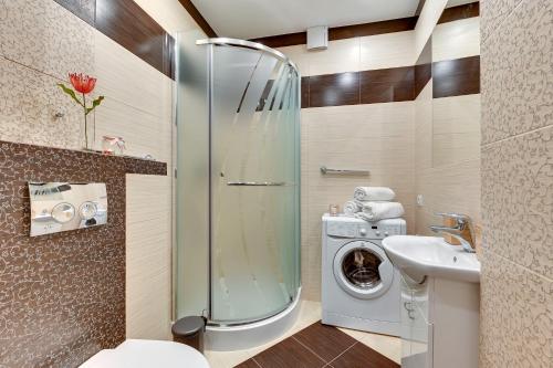 y baño con lavadora y lavamanos. en Cooleq Apartments Ogarna by TriApart en Gdansk