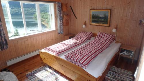 A bed or beds in a room at Angvik Fjordferie