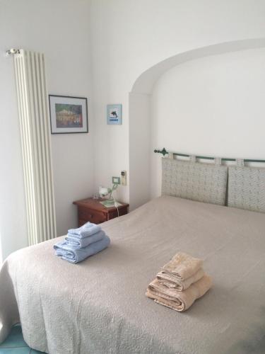 a bedroom with a bed with towels on it at LA CASETTA DI ERIKA in Lacco Ameno