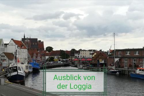 a sign that reads austbushon der loogeoria on a river with at Schnieke Hüsing in Wismar