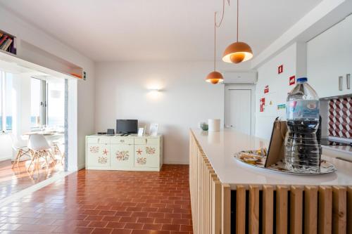 a kitchen with a large bottle on a counter at Ria Beach House in Faro