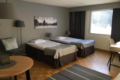 Ένα ή περισσότερα κρεβάτια σε δωμάτιο στο Hotel Yöpuu