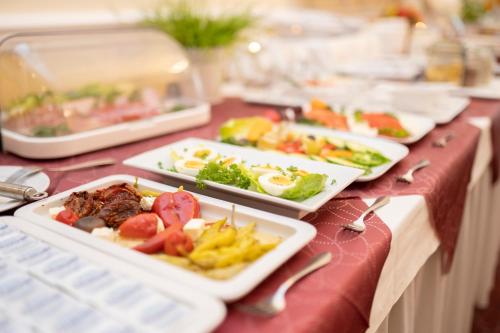 a buffet with plates of food on a table at Palais am Kleistpark in Frankfurt/Oder