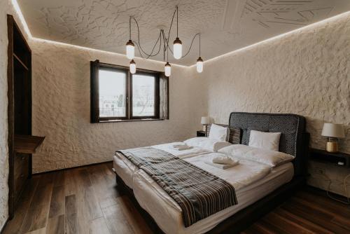 מיטה או מיטות בחדר ב-Pastorale Apartman