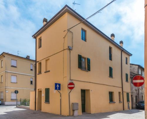 a yellow building on the side of a street at Hotel Antico Borgo in Riolo Terme