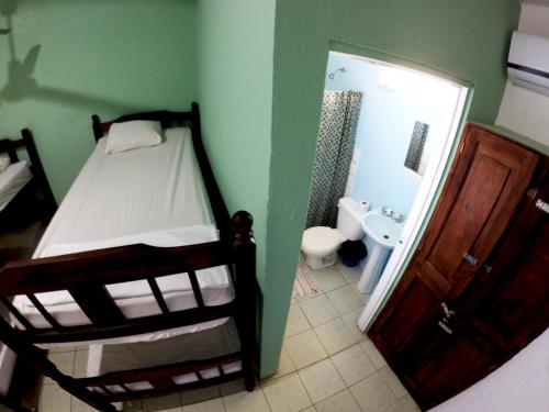 Una cama o camas en una habitación de Tsunami Hostel