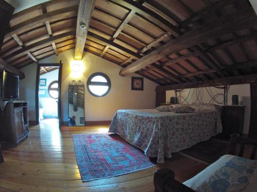 a bedroom with a bed in a room with wooden ceilings at Antica Pietrara B&B in Formello