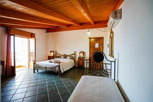 a bedroom with a bed and a balcony at Hotel Residence Costa Azzurra in Capo Vaticano