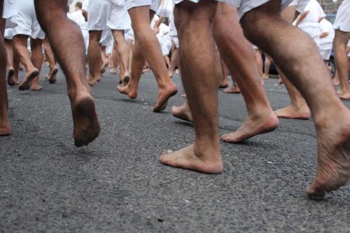 a group of people walking down a street with their bare feet at Il Quarzo in Càbras