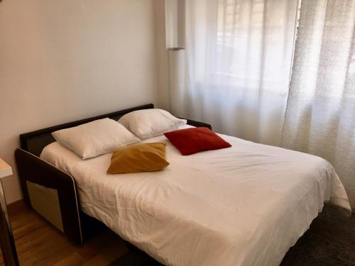 ein Schlafzimmer mit einem Bett mit zwei Kissen darauf in der Unterkunft Aux bons amis - Parlement/Orangerie in Straßburg