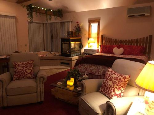 a living room with a bed and a couch and chairs at HIllside Farm B & B in Mount Joy