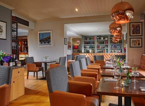 a restaurant with a long table and chairs at Castlecourt Hotel, Spa & Leisure in Westport