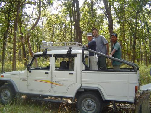 three people standing in the back of a white truck at Rhino Lodge Bardia Pvt Ltd in Bhurkīā