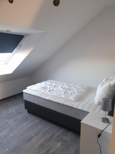a bed in a room with a white ceiling at ANJA'S motel in Bruchmühlbach-Miesau