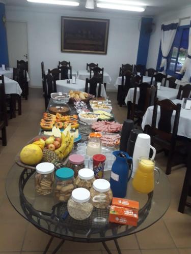 a glass table with food on top of it at Hotel Nevada Ubatuba in Ubatuba