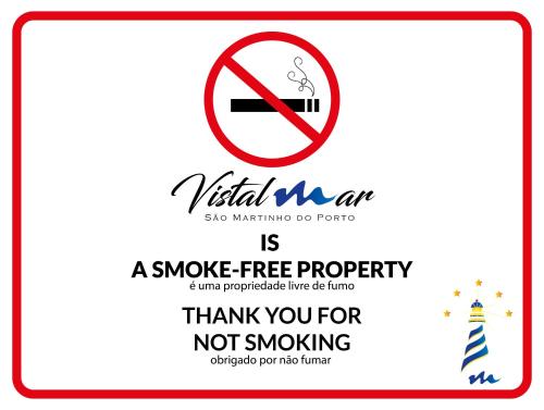 a sign that says a smoke free property with a cigarette at Vistalmar São Martinho in São Martinho do Porto