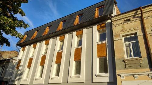 an old building with windows on top of it at Hostel Tarnopil in Ternopilʼ