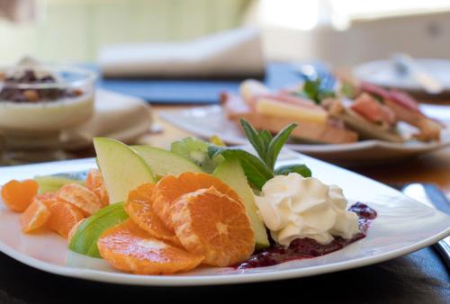 a white plate of fruit on a table at Hotel y Termas Huife in Termas De Huife