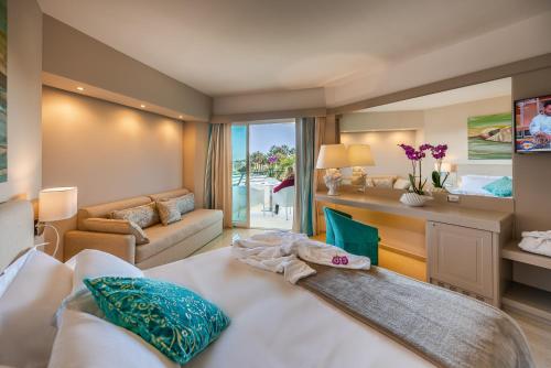 a bedroom with a bed and a living room at Acacia Palace in Marina di Ragusa