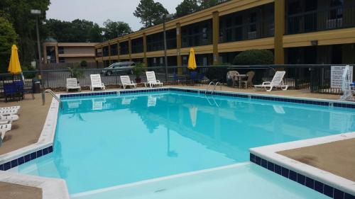 a large blue swimming pool in front of a hotel at Days Inn by Wyndham Attalla in Attalla