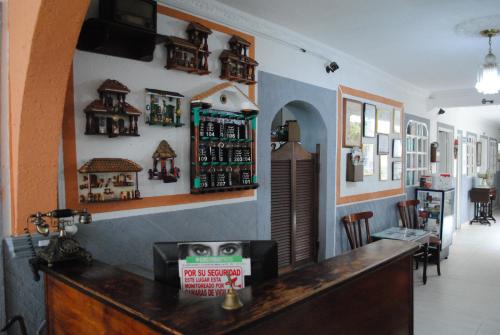 a bar in a restaurant with a counter and chairs at Hotel Ciudad Señora Buga in Buga