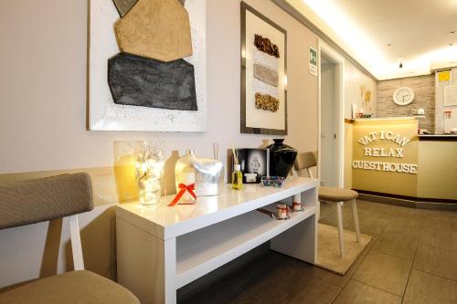 a room with a counter with a table and chairs at Domus Castroni Pompeo Magno in Rome