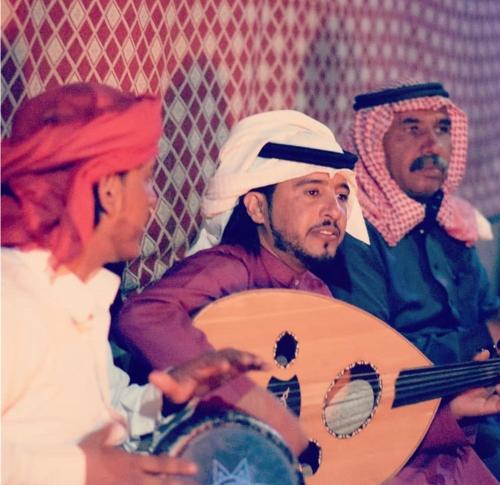 a group of three people sitting next to a woman at Wadi Rum Travel camp in Wadi Rum