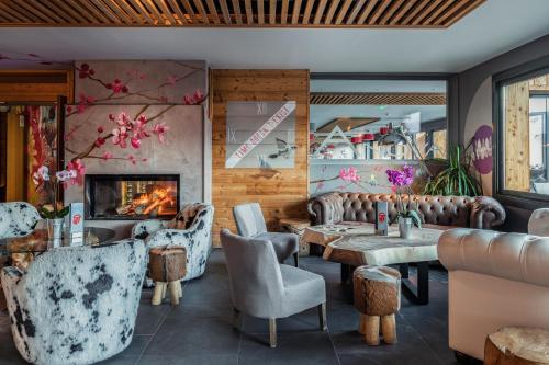 a restaurant with tables and chairs and a fireplace at Anova Hotel & Spa in Montgenèvre