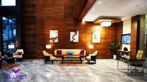 a lobby with a couch and chairs in a building at Velvet Hotel Jeddah in Jeddah