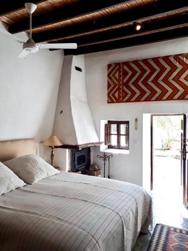 a bedroom with a large bed and a ceiling at encantadora casa ibicenca in Sant Josep de sa Talaia
