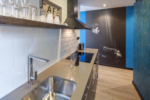 a kitchen with a sink and a counter top at Habitat Apartments Cool Jazz in Barcelona
