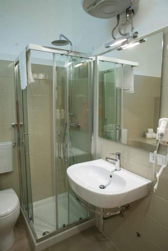 a bathroom with a sink and a glass shower at Masseria Nzeta in Carovigno