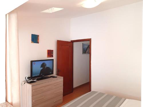 a living room with a television on a dresser at The Terrace in Vernazza